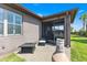 A patio with brick floors, wicker furniture, and a view of the backyard with tall palm trees at 1321 Custer Bayou St, Ruskin, FL 33570