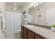 Bathroom with decorative mirror, shelving, shower with curtain, vanity, toilet and granite countertops at 1321 Custer Bayou St, Ruskin, FL 33570