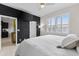 Sizable bedroom featuring a black accent wall, bright windows and views to the kitchen at 1321 Custer Bayou St, Ruskin, FL 33570
