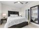 Comfortable bedroom with a queen-size bed, neutral bedding, side tables with lamps and a full length mirror at 1321 Custer Bayou St, Ruskin, FL 33570