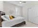 Bedroom with a ceiling fan, plantation shutters, closet and bed with decorative pillows at 1321 Custer Bayou St, Ruskin, FL 33570