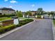 The gated community entrance with lush landscaping and signage offers privacy and an upscale feel at 1321 Custer Bayou St, Ruskin, FL 33570