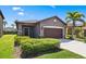 Charming single-story home featuring a well-manicured lawn and a two-car garage at 1321 Custer Bayou St, Ruskin, FL 33570