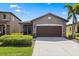 Charming single-story home featuring a well-manicured lawn and a two-car garage at 1321 Custer Bayou St, Ruskin, FL 33570