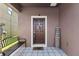Inviting front porch with decorative tiles, a welcome sign, and a cozy bench at 1321 Custer Bayou St, Ruskin, FL 33570