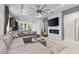 Open-concept living room featuring a modern fireplace and a large sectional sofa at 1321 Custer Bayou St, Ruskin, FL 33570