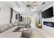 Open-concept living room featuring a modern fireplace and a large sectional sofa at 1321 Custer Bayou St, Ruskin, FL 33570