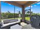 Screened patio with wicker furniture and a view of the backyard at 1321 Custer Bayou St, Ruskin, FL 33570