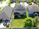 Aerial view of home with a large backyard, screened in porch, and solar panels at 13903 Sage Thrasher Ln, Riverview, FL 33579