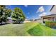 View of a spacious backyard with a manicured lawn, bordered by a white fence at 13903 Sage Thrasher Ln, Riverview, FL 33579