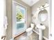Bathroom with walk-out access door with full-light privacy glass to an outdoor space at 13903 Sage Thrasher Ln, Riverview, FL 33579