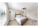 Bedroom features a bed, ceiling fan, and a window at 13903 Sage Thrasher Ln, Riverview, FL 33579