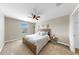 Bedroom featuring a queen bed, carpet, a fan, and a window for natural light at 13903 Sage Thrasher Ln, Riverview, FL 33579