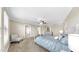 Bright bedroom features a ceiling fan, large windows, carpet flooring, and neutral decor at 13903 Sage Thrasher Ln, Riverview, FL 33579