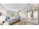 Bright bedroom boasts natural light from the large windows, carpet flooring, and neutral decor at 13903 Sage Thrasher Ln, Riverview, FL 33579
