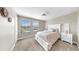 Cozy bedroom features a bed, windows for natural light, soft carpet, and neutral decor at 13903 Sage Thrasher Ln, Riverview, FL 33579