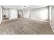 Spacious upper level bonus room with neutral carpeting and ample natural light at 13903 Sage Thrasher Ln, Riverview, FL 33579