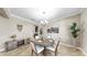Bright dining area with a round table, stylish decor, and a view into other rooms at 13903 Sage Thrasher Ln, Riverview, FL 33579