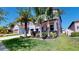 Charming two-story home featuring a dark garage door, landscaped yard, and inviting front porch at 13903 Sage Thrasher Ln, Riverview, FL 33579