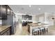 Modern kitchen with granite countertops, a stainless steel refrigerator, and dark cabinetry at 13903 Sage Thrasher Ln, Riverview, FL 33579
