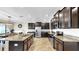 Spacious kitchen featuring stainless steel appliances, granite countertops, and dark cabinetry at 13903 Sage Thrasher Ln, Riverview, FL 33579