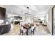 Open-concept kitchen and dining area with modern lighting fixtures at 13903 Sage Thrasher Ln, Riverview, FL 33579