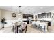 Modern eat-in kitchen features dark wood cabinets, stainless steel appliances, and a large granite island at 13903 Sage Thrasher Ln, Riverview, FL 33579