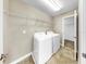 Bright laundry room features a washer, dryer and wire shelving for optimal organization and storage at 13903 Sage Thrasher Ln, Riverview, FL 33579