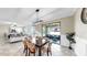 Bright and airy living room adjacent to the dining area with large windows at 13903 Sage Thrasher Ln, Riverview, FL 33579