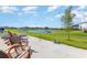 Tranquil backyard with a concrete patio and scenic pond views perfect for outdoor relaxation at 13958 Richland Gulf Cir, Parrish, FL 34219