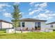 A spacious backyard features a patio with chairs and a lush lawn, perfect for outdoor enjoyment at 13958 Richland Gulf Cir, Parrish, FL 34219