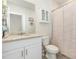 Neutral bathroom with granite countertop vanity, decorative storage, and a shower-tub combo at 13958 Richland Gulf Cir, Parrish, FL 34219
