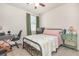 Cozy bedroom featuring a ceiling fan, a bed, and carpet floors with natural light from the window at 13958 Richland Gulf Cir, Parrish, FL 34219
