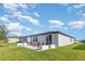 Home's exterior featuring a concrete patio and well-maintained lawn with a serene neighborhood view at 13958 Richland Gulf Cir, Parrish, FL 34219