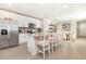 Bright, open kitchen with white cabinets, stainless steel appliances, and a large island with barstool seating at 13958 Richland Gulf Cir, Parrish, FL 34219