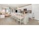 Modern kitchen with a breakfast bar, white cabinetry, stainless steel appliances, and stylish backsplash at 13958 Richland Gulf Cir, Parrish, FL 34219
