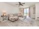 Comfortable living room with a plush sectional sofa, stylish rug, and sliding glass doors to the patio at 13958 Richland Gulf Cir, Parrish, FL 34219