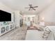 Open-concept living room showcasing a modern entertainment center, flowing into the kitchen and dining area at 13958 Richland Gulf Cir, Parrish, FL 34219