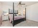 Comfortable main bedroom featuring a four-poster bed, ceiling fan, and ensuite bathroom access at 13958 Richland Gulf Cir, Parrish, FL 34219