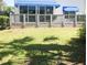 Well-maintained backyard with manicured lawn and an elevated patio with railings at 14840 Shipwatch Trce # 1924, Largo, FL 33774