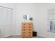 Bright bedroom featuring a closet, dresser, and window for natural light at 14840 Shipwatch Trce # 1924, Largo, FL 33774