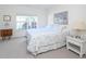 Inviting bedroom with a soft color palette, a large window, and cozy furnishings at 14840 Shipwatch Trce # 1924, Largo, FL 33774