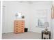 Bedroom with natural light from the window and a 5 drawer wooden dresser at 14840 Shipwatch Trce # 1924, Largo, FL 33774