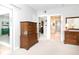 Spacious bedroom featuring neutral walls and carpet with a view to the ensuite bathroom at 14840 Shipwatch Trce # 1924, Largo, FL 33774