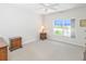 Bright bedroom featuring a window and neutral walls with a ceiling fan at 14840 Shipwatch Trce # 1924, Largo, FL 33774