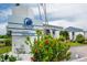 Welcome to Shipwatch Yacht and Tennis Club; sign in front of the clubhouse, surrounded by colorful flowers and lush greenery at 14840 Shipwatch Trce # 1924, Largo, FL 33774