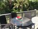 Relaxing deck with outdoor seating and views of lush greenery at 14840 Shipwatch Trce # 1924, Largo, FL 33774