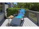 Relaxing outdoor deck with a blue chair and a sun hat at 14840 Shipwatch Trce # 1924, Largo, FL 33774