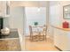 Bright breakfast nook features a small dining table with seating for two near a window at 14840 Shipwatch Trce # 1924, Largo, FL 33774