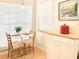 Cozy dining area features a small table with seating for two and natural light from the window at 14840 Shipwatch Trce # 1924, Largo, FL 33774